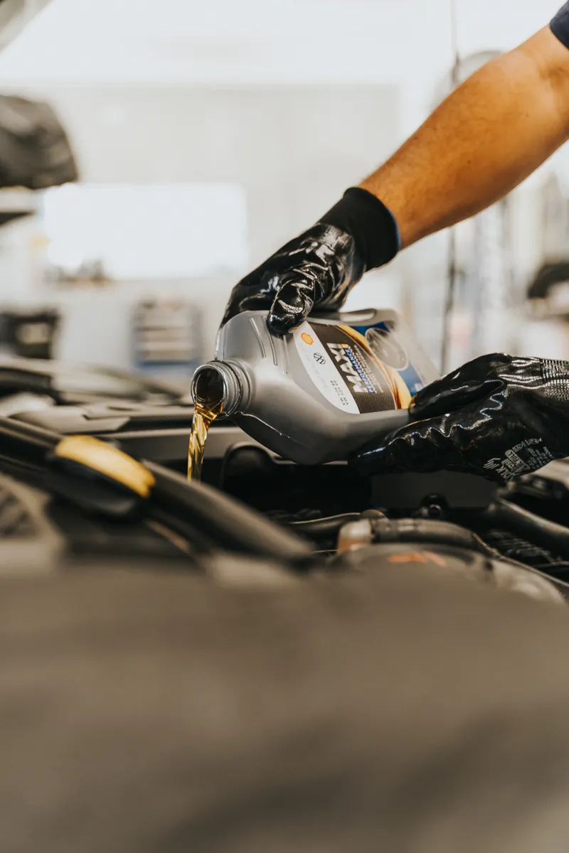 Engine oil being poured during a service
