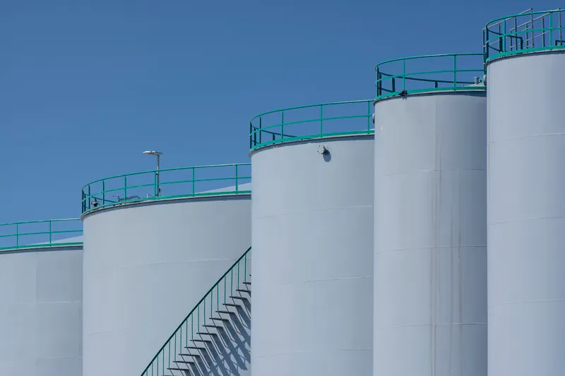 Bulk fuel storage tanks with access stairways